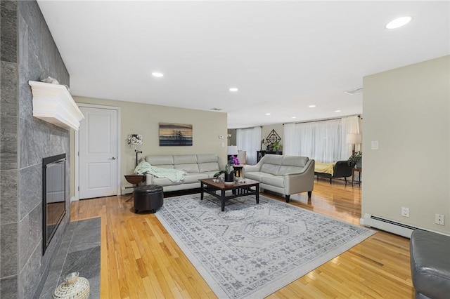 48 Nottingham Dr, Scituate, RI 02831 - living area with a fireplace, wood finished floors, recessed lighting, and baseboard heating
