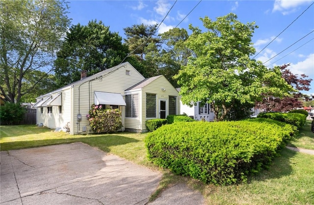 25 Community Rd, Warwick, RI 02889 - view of front of home featuring a front lawn and a chimney