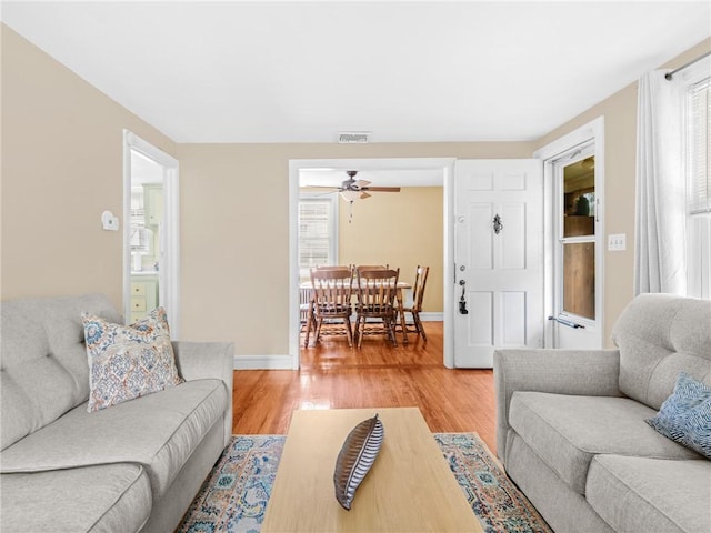 25 Community Rd, Warwick, RI 02889 - living area with plenty of natural light, a ceiling fan, light wood-style floors, and baseboards