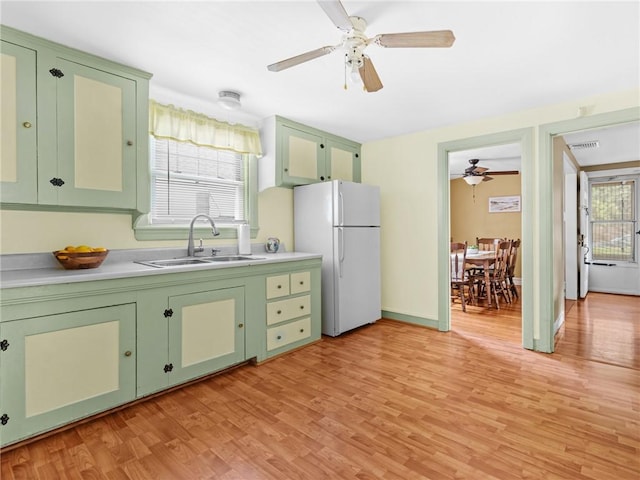 25 Community Rd, Warwick, RI 02889 - kitchen featuring green cabinets, freestanding refrigerator, a ceiling fan, a sink, and light wood finished floors