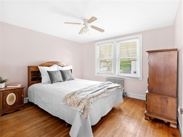 25 Community Rd, Warwick, RI 02889 - bedroom with wood-type flooring, baseboards, radiator, and ceiling fan