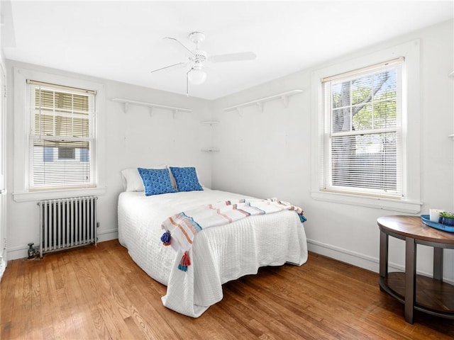 25 Community Rd, Warwick, RI 02889 - bedroom featuring radiator, wood finished floors, baseboards, and a ceiling fan