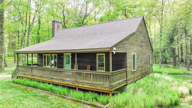 212 Absalona Hill Rd, Glocester, RI 02814 - view of front of home with a chimney, a shingled roof, and a wooded view