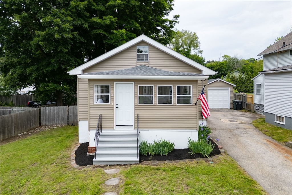 12 Broad St, Coventry, RI 02816 - view of front facade featuring an outbuilding, a garage, driveway, and roof with shingles