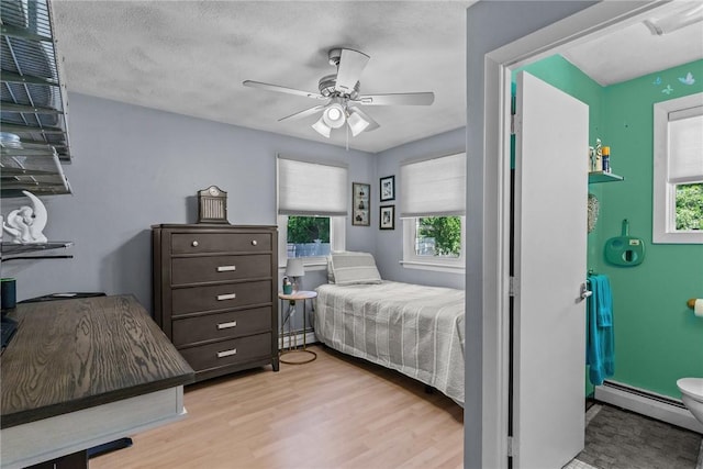 21 High Service Ave, North Providence, RI 02911 - bedroom with a baseboard heating unit, wood finished floors, ceiling fan, and a baseboard radiator