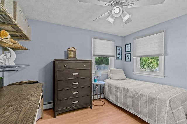 21 High Service Ave, North Providence, RI 02911 - bedroom featuring light wood-style flooring, a ceiling fan, and a baseboard radiator