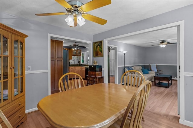 21 High Service Ave, North Providence, RI 02911 - dining room featuring ceiling fan, light wood-style flooring, and baseboards