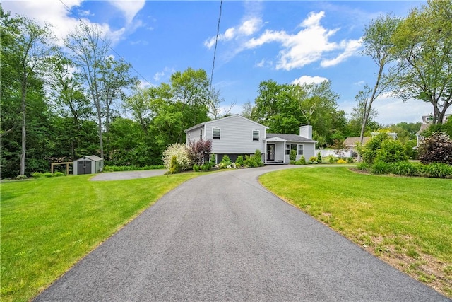 50 Maureen Dr, Smithfield, RI 02917 - tri-level home featuring a chimney and a front yard