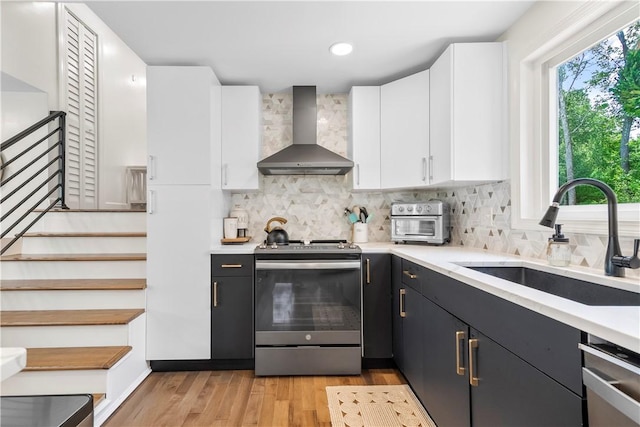 50 Maureen Dr, Smithfield, RI 02917 - kitchen featuring wall chimney exhaust hood, electric stove, a sink, white cabinets, and light countertops