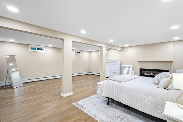 50 Maureen Dr, Smithfield, RI 02917 - bedroom with light wood-style flooring, recessed lighting, baseboard heating, a glass covered fireplace, and baseboards