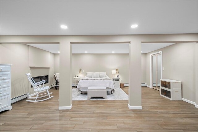 50 Maureen Dr, Smithfield, RI 02917 - bedroom with baseboard heating, light wood-style floors, recessed lighting, a baseboard heating unit, and a fireplace