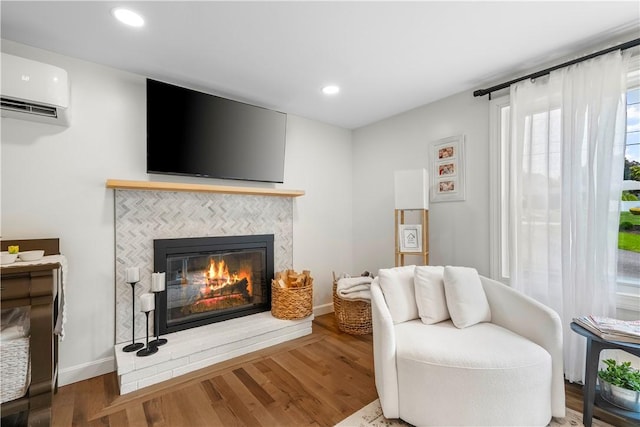 50 Maureen Dr, Smithfield, RI 02917 - sitting room with an AC wall unit, a tile fireplace, wood finished floors, recessed lighting, and baseboards