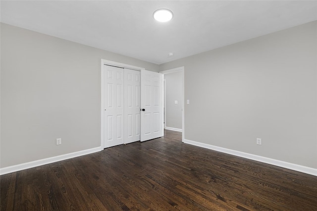 21 Victor Emanuel Ave, Providence, RI 02904 - unfurnished bedroom with baseboards, dark wood-style floors, and a closet