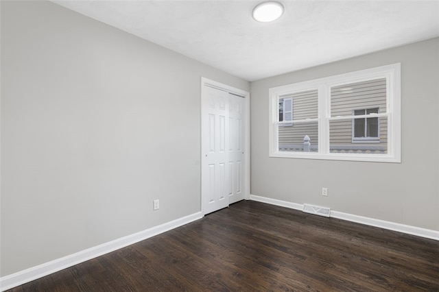 21 Victor Emanuel Ave, Providence, RI 02904 - unfurnished bedroom with baseboards, dark wood-style flooring, and a closet
