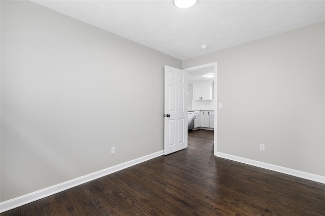 21 Victor Emanuel Ave, Providence, RI 02904 - empty room featuring dark wood-style flooring, baseboards, and a smoke detector