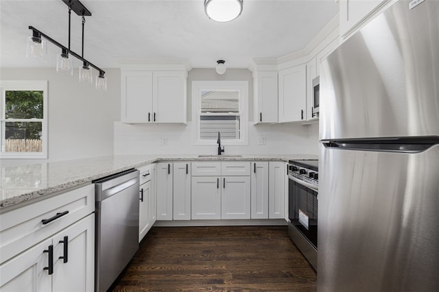 21 Victor Emanuel Ave, Providence, RI 02904 - kitchen with appliances with stainless steel finishes, a sink, dark wood-style flooring, backsplash, and white cabinetry
