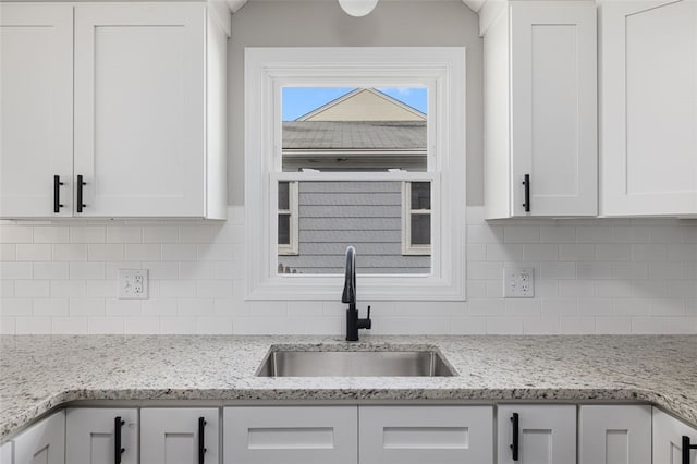 21 Victor Emanuel Ave, Providence, RI 02904 - kitchen featuring a sink, white cabinetry, tasteful backsplash, and light stone counters