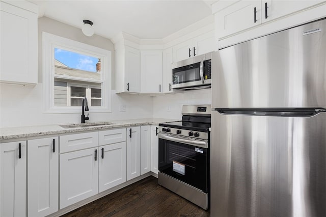 21 Victor Emanuel Ave, Providence, RI 02904 - kitchen with stainless steel appliances, a sink, dark wood-style flooring, tasteful backsplash, and white cabinets