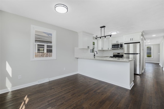 21 Victor Emanuel Ave, Providence, RI 02904 - kitchen featuring stainless steel appliances, a peninsula, a sink, white cabinets, and dark wood finished floors