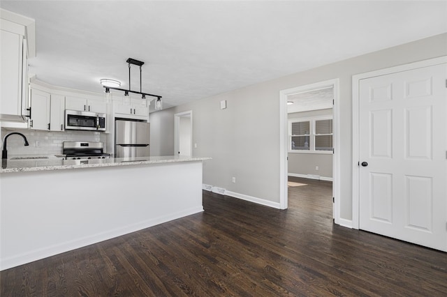 21 Victor Emanuel Ave, Providence, RI 02904 - kitchen with appliances with stainless steel finishes, a sink, light stone counters, a peninsula, and dark wood-style floors