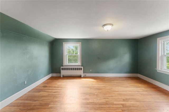 282 Seven Mile Rd, Scituate, RI 02831 - spare room featuring radiator heating unit, wood finished floors, baseboards, and lofted ceiling