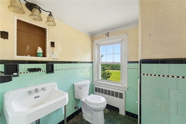 282 Seven Mile Rd, Scituate, RI 02831 - bathroom with radiator, tile walls, a sink, wainscoting, and toilet