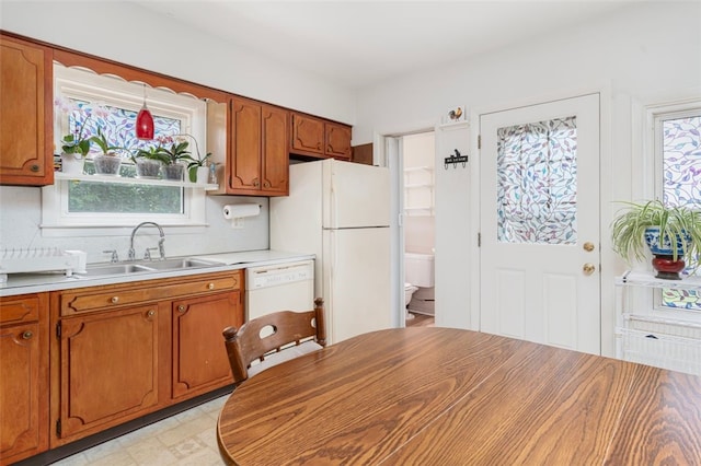 32 N Clarendon St, Cranston, RI 02910 - kitchen with a sink, plenty of natural light, brown cabinets, and white appliances