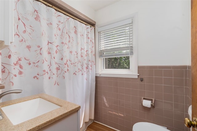 32 N Clarendon St, Cranston, RI 02910 - full bath featuring tile walls, toilet, vanity, a shower with shower curtain, and wainscoting