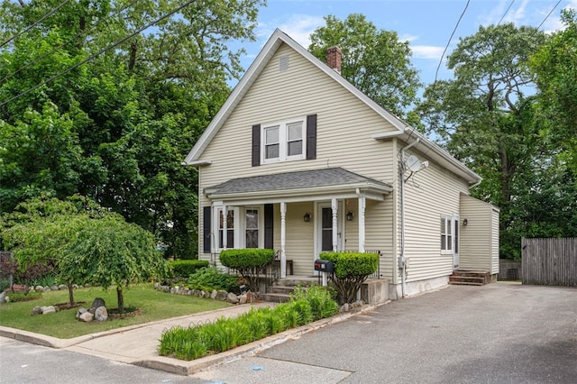 32 N Clarendon St, Cranston, RI 02910 - view of front of house with a porch, a chimney, and asphalt driveway