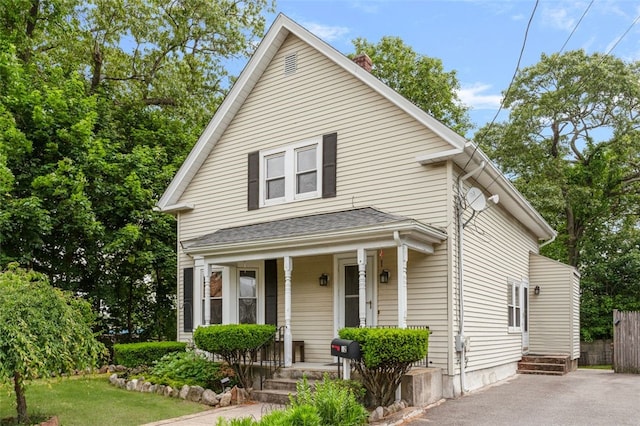 32 N Clarendon St, Cranston, RI 02910 - view of front facade featuring a porch and asphalt driveway