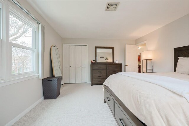 2970 Mendon Rd Unit 53, Cumberland, RI 02864 - bedroom with baseboards, light carpet, and a closet