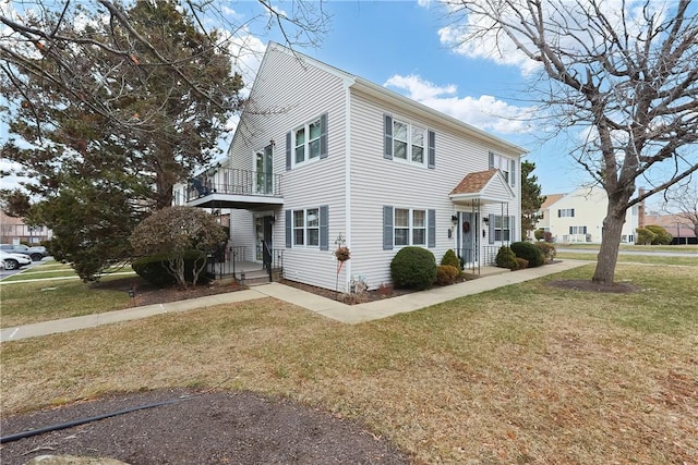 2970 Mendon Rd Unit 53, Cumberland, RI 02864 - view of side of home with a lawn and a balcony