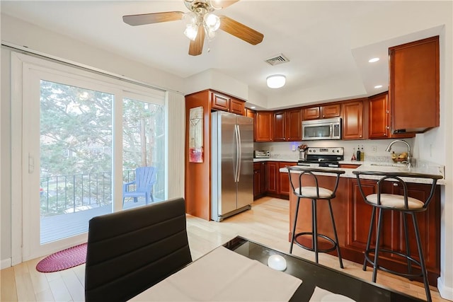 2970 Mendon Rd Unit 53, Cumberland, RI 02864 - kitchen featuring appliances with stainless steel finishes, a sink, light wood finished floors, a peninsula, and recessed lighting