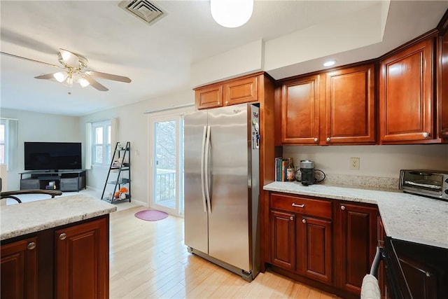 2970 Mendon Rd Unit 53, Cumberland, RI 02864 - kitchen with freestanding refrigerator, light wood-style flooring, a ceiling fan, range, and light stone countertops
