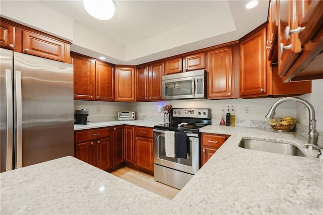 2970 Mendon Rd Unit 53, Cumberland, RI 02864 - kitchen featuring stainless steel appliances, a sink, light stone counters, recessed lighting, and light wood-style floors