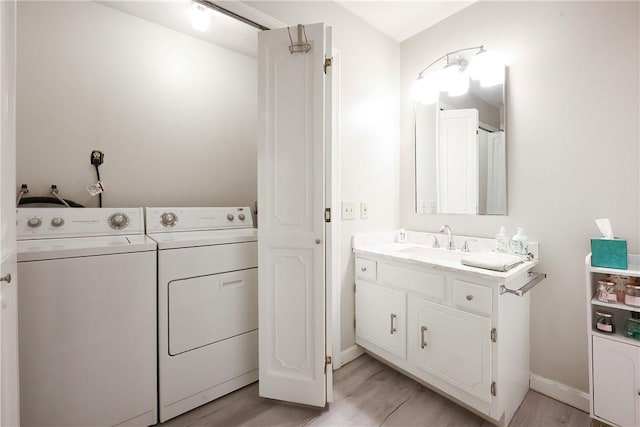 2970 Mendon Rd Unit 53, Cumberland, RI 02864 - bathroom featuring separate washer and dryer, vanity, wood finished floors, and baseboards