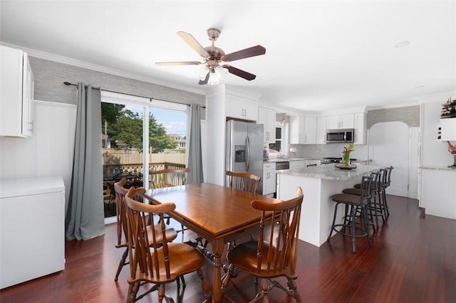 6 Humes Ave, Warwick, RI 02889 - dining area with dark wood-style floors, a ceiling fan, and crown molding