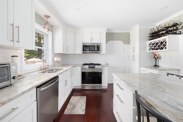 6 Humes Ave, Warwick, RI 02889 - kitchen with stainless steel appliances, white cabinetry, light stone counters, tasteful backsplash, and crown molding