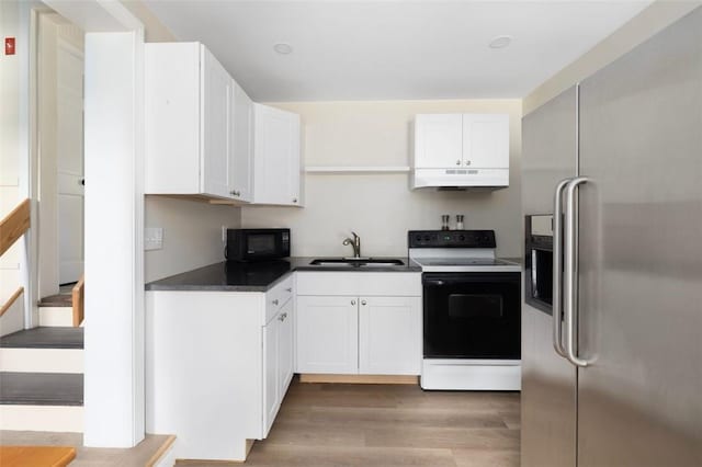 6 Humes Ave, Warwick, RI 02889 - kitchen featuring stainless steel fridge with ice dispenser, electric stove, under cabinet range hood, black microwave, and light wood-style floors