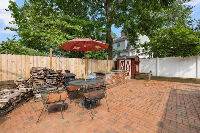 6 Humes Ave, Warwick, RI 02889 - fenced backyard featuring a shed, a patio, and outdoor dining space