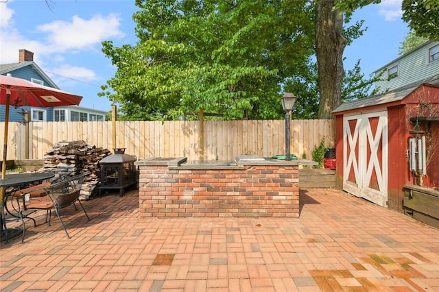 6 Humes Ave, Warwick, RI 02889 - fenced backyard featuring a patio, a storage unit, exterior kitchen, and outdoor dining area