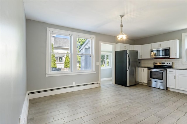 103 Henrietta St, Providence, RI 02904 - kitchen featuring appliances with stainless steel finishes, dark countertops, backsplash, white cabinets, and decorative light fixtures