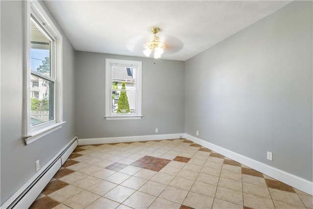 103 Henrietta St, Providence, RI 02904 - empty room with a baseboard heating unit, ceiling fan, light tile patterned floors, and baseboards