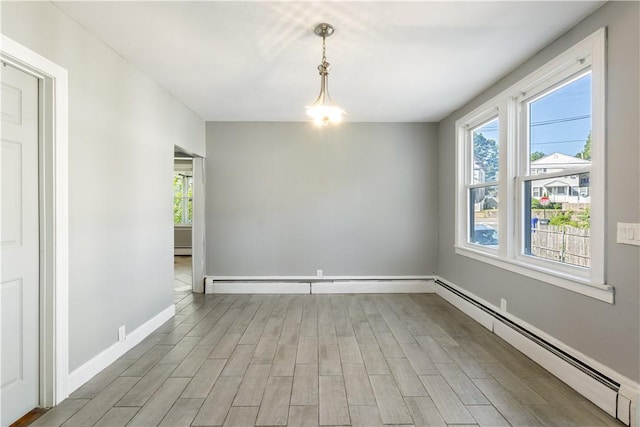 103 Henrietta St, Providence, RI 02904 - empty room with a baseboard heating unit, light wood finished floors, and baseboards