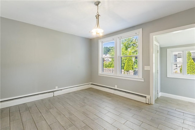 103 Henrietta St, Providence, RI 02904 - empty room with plenty of natural light, a baseboard heating unit, light wood-style floors, and baseboards