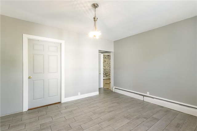 103 Henrietta St, Providence, RI 02904 - unfurnished room featuring baseboard heating, wood finished floors, and baseboards