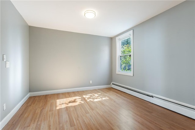 103 Henrietta St, Providence, RI 02904 - empty room with baseboard heating, light wood-style floors, and baseboards