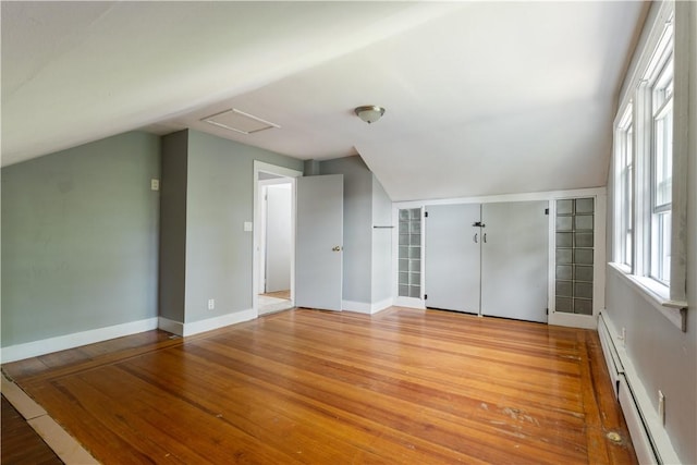 103 Henrietta St, Providence, RI 02904 - additional living space featuring baseboard heating, vaulted ceiling, attic access, wood finished floors, and baseboards