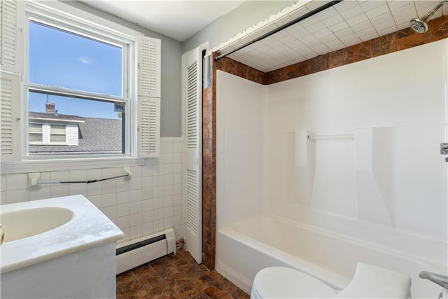 103 Henrietta St, Providence, RI 02904 - full bath with baseboard heating, tile walls, shower / bath combination, vanity, and toilet