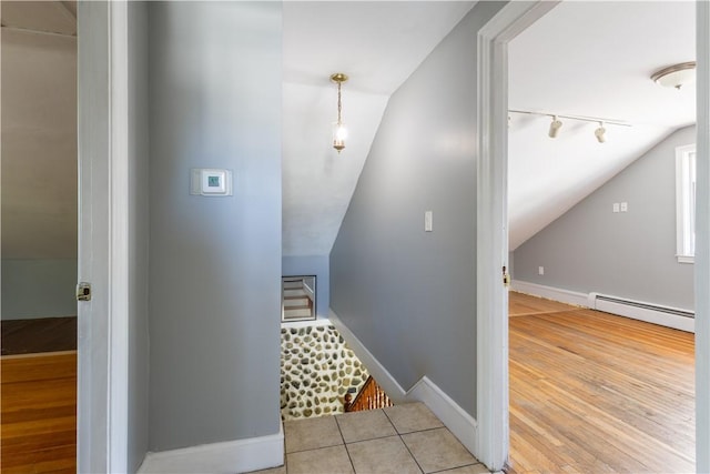 103 Henrietta St, Providence, RI 02904 - stairway with a baseboard radiator, vaulted ceiling, rail lighting, baseboards, and wood finished floors